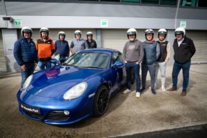 Group photo next to a Porsche Cayman at Mondello Park