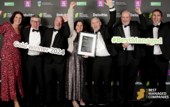 The Instantor Team smiling and cheering holding up their Best Managed Companies award at the awards event